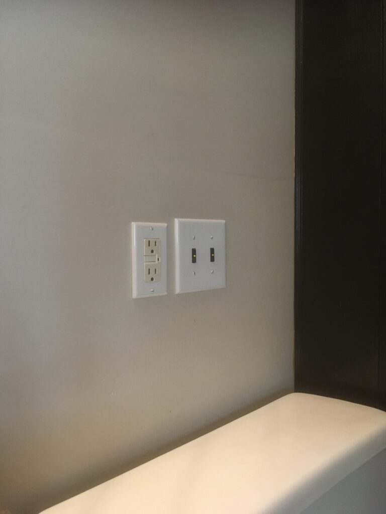 Two working Touchless Light Switches by the ground fault outlet in the bathroom